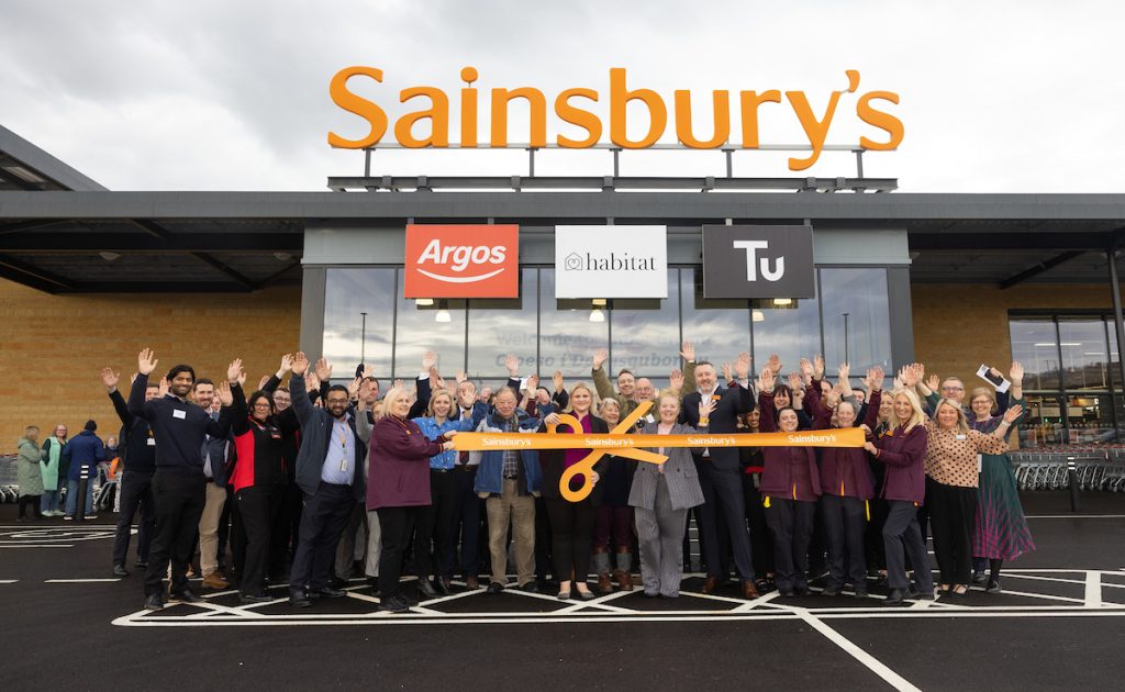 Sainsbury's store Talbot Green Wales, with colleagues outside holding a large scissors orange store opening type ribbon