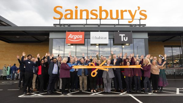 Sainsbury's store Talbot Green Wales, with colleagues outside holding a large scissors orange store opening type ribbon