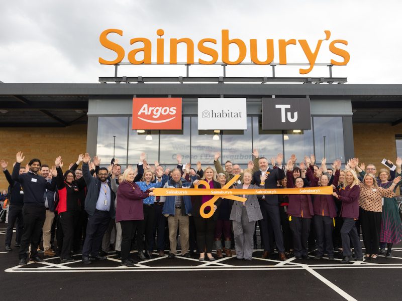 Sainsbury's store Talbot Green Wales, with colleagues outside holding a large scissors orange store opening type ribbon