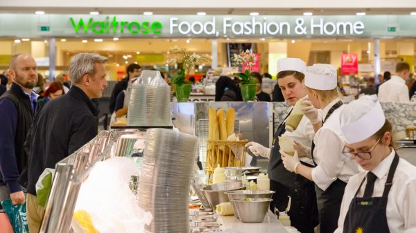 Here depicting staff serving customers at a Waitrose counter