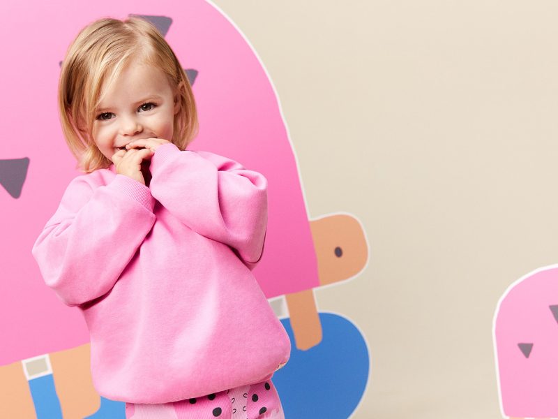 Asda - Here depicting a child wearing a pink Asda gender neutral Little Angels outfit