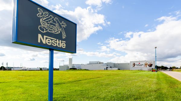 Nestlé sign on a field with green grass