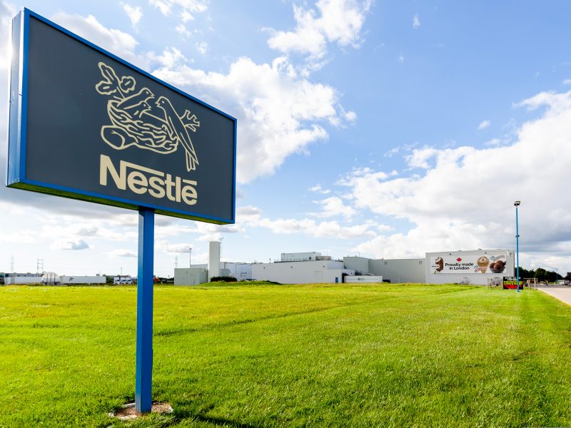 Nestlé sign on a field with green grass