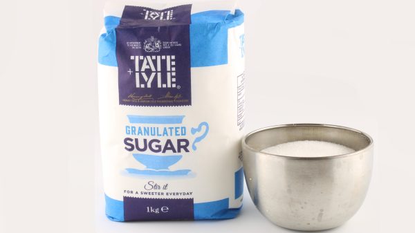 Here showing a branded Tate & Lyle Sugars pack next to a silver bowl of sugar