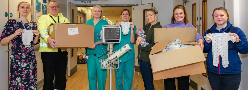 Tesco is to donate 23,000 packs of own-brand premature baby clothes to neonatal wards in hospitals across the UK, here showing NHS staff, parents and Tesco employees with premature baby clothes
