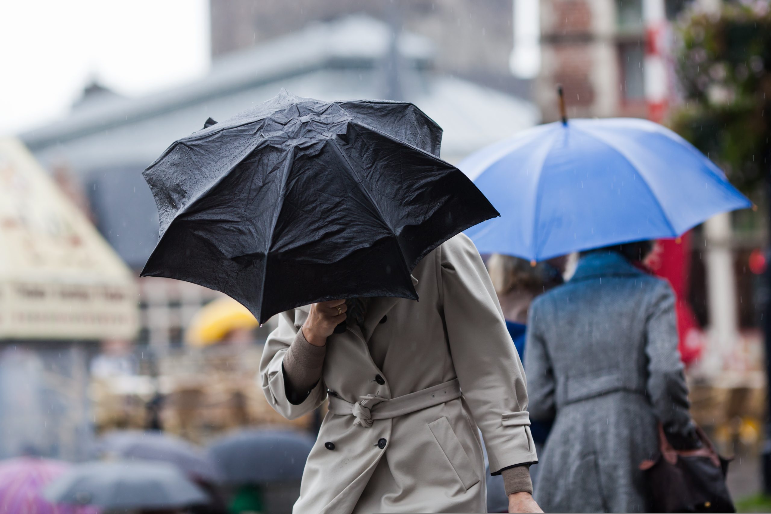 Footfall Here showing someone battling the rain - UK food retail stores' sales volumes fell by 0.3% over February as figures were blamed on "unsettled weather" from "wettest February on record".